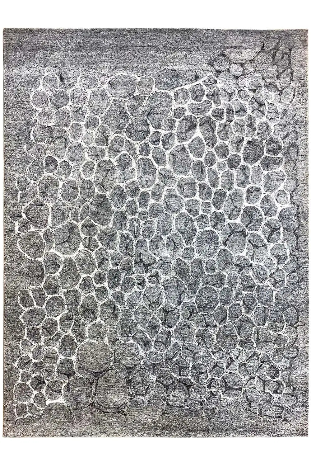 Hand-tufted rug with a gray raised pattern made of many small wave stones