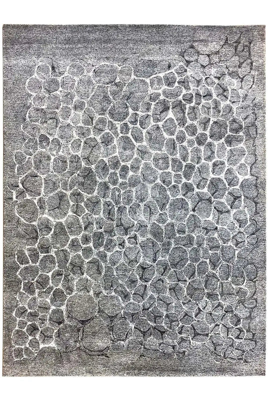 Hand-tufted rug with a gray raised pattern made of many small wave stones