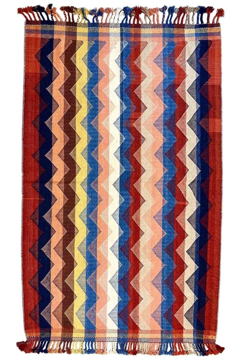 Vertically oriented rug with a zigzag pattern in red, blue, and cream, with fringes on all sides.