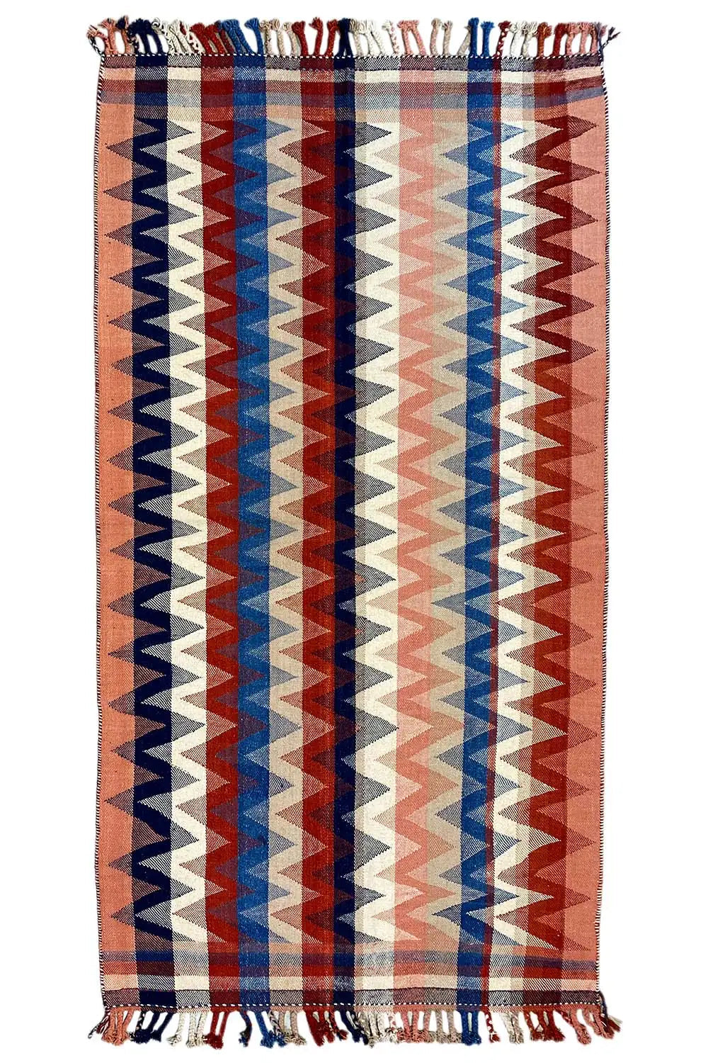 Rectangular rug with a geometric zigzag pattern in brown, blue, red, and beige, with fringes