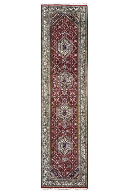 Bidjar runner with a red border and medallion pattern, dark central stripe