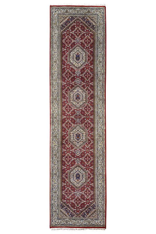Bidjar runner with a red border and medallion pattern, dark central stripe