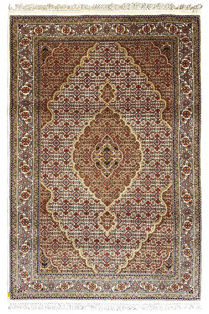 Oriental rug with a central medallion, brown and beige pattern, and fringes all around