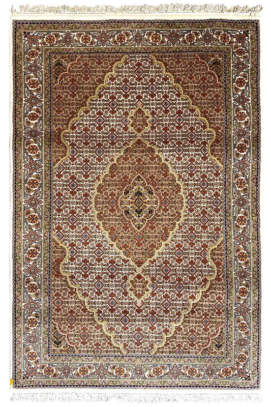 Oriental rug with a central medallion, brown and beige pattern, and fringes all around