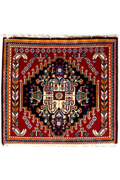 Square Oriental rug with a black center, burgundy border, and symmetrical ornamental pattern