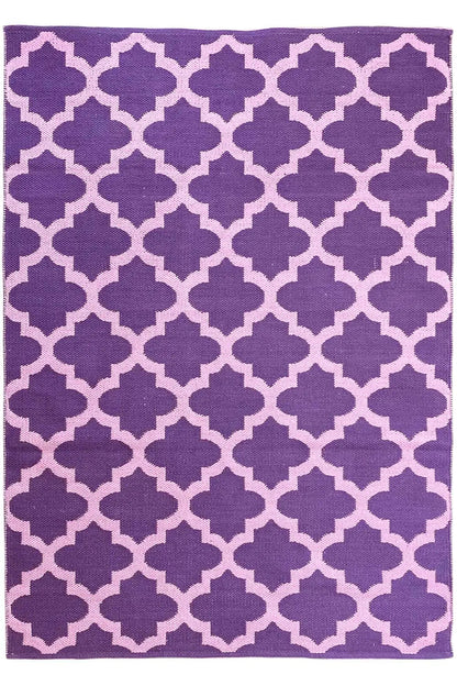 Rectangular rug with a purple background and a geometric quarter-flower pattern in violet