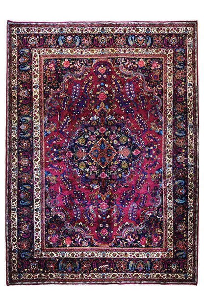 Khorasan rug with red medallion, blue border, and ornamental pattern