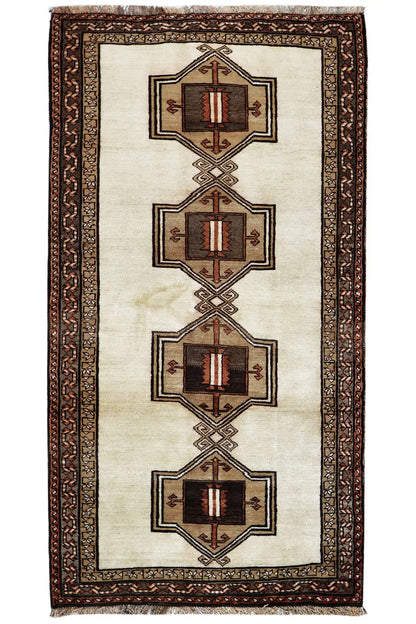 Oriental rug with a beige field, brown decorative border, and four medallions in a row.