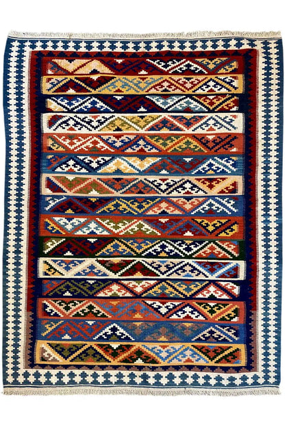 Kilim rug with a framed pattern, white border with blue elements, and multicolored edging.