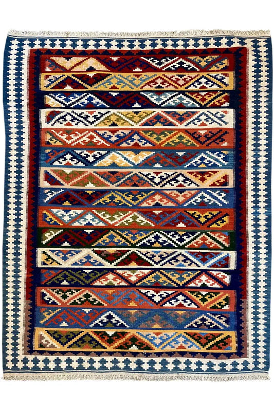 Kilim rug with a framed pattern, white border with blue elements, and multicolored edging.