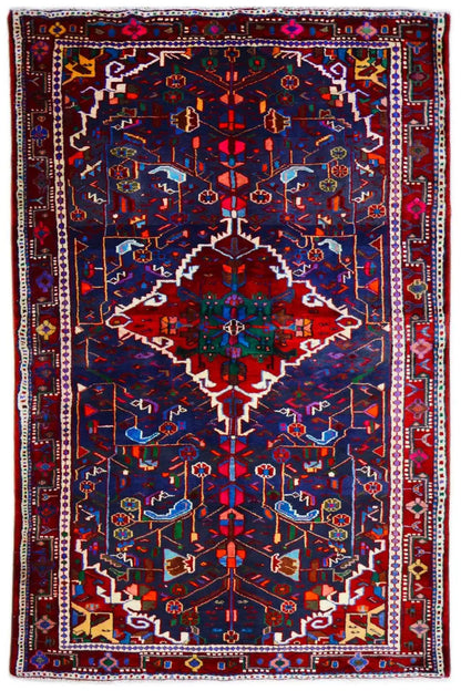 Almost square Hamadan rug with a dark blue pattern, red accents, and a border.