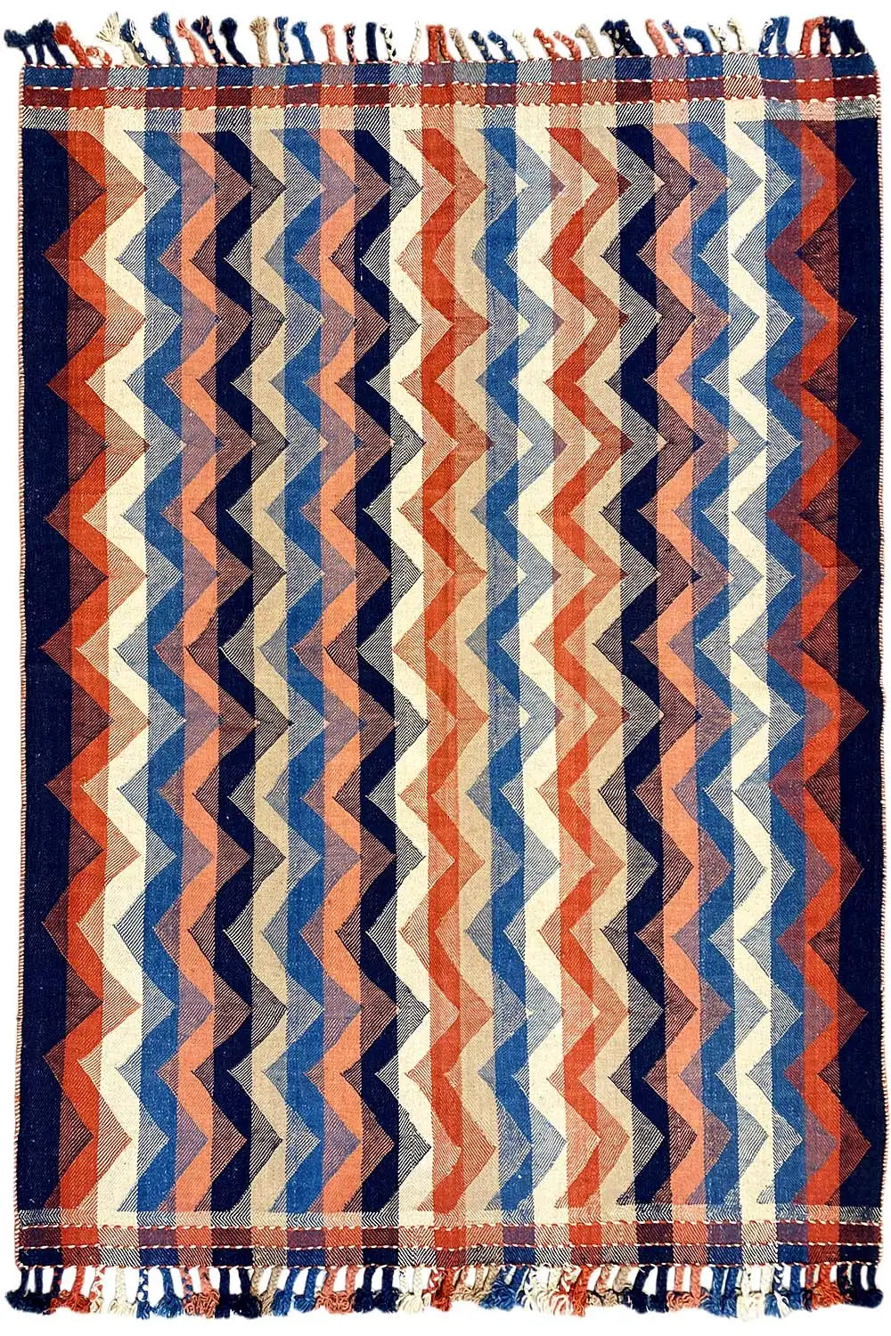 Multicolored rug in a chevron zigzag design, with fringes along the edge