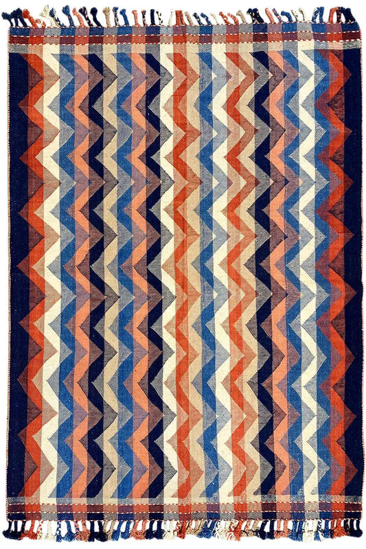 Multicolored rug in a chevron zigzag design, with fringes along the edge