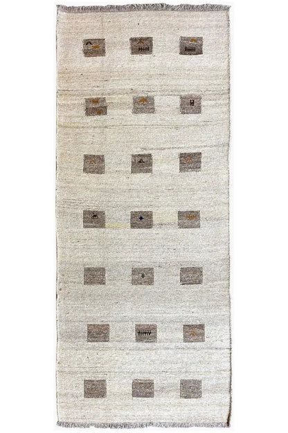Kilim runner with a beige background and rectangular square patterns in brown, fringed edge