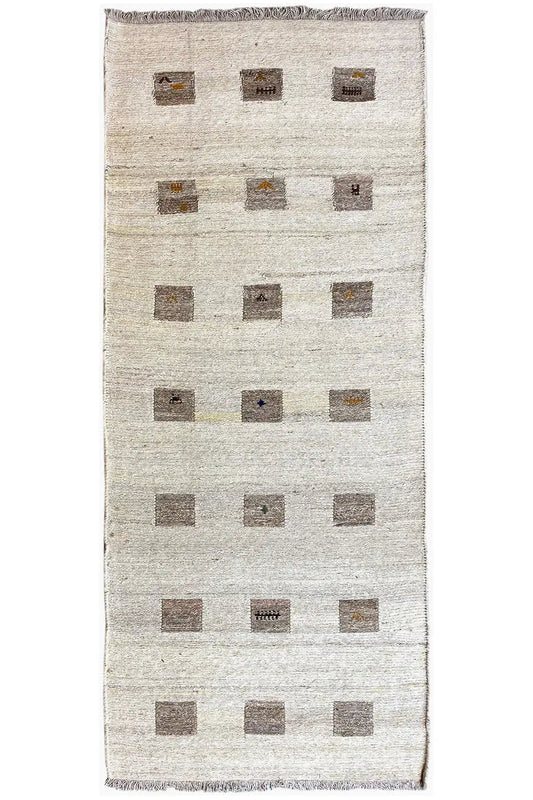 Kilim runner with a beige background and rectangular square patterns in brown, fringed edge
