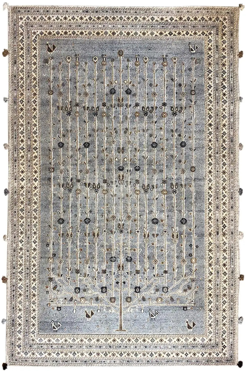 Rug with a blue-gray background, golden-beige chain ornaments, a beige border, and tassels
