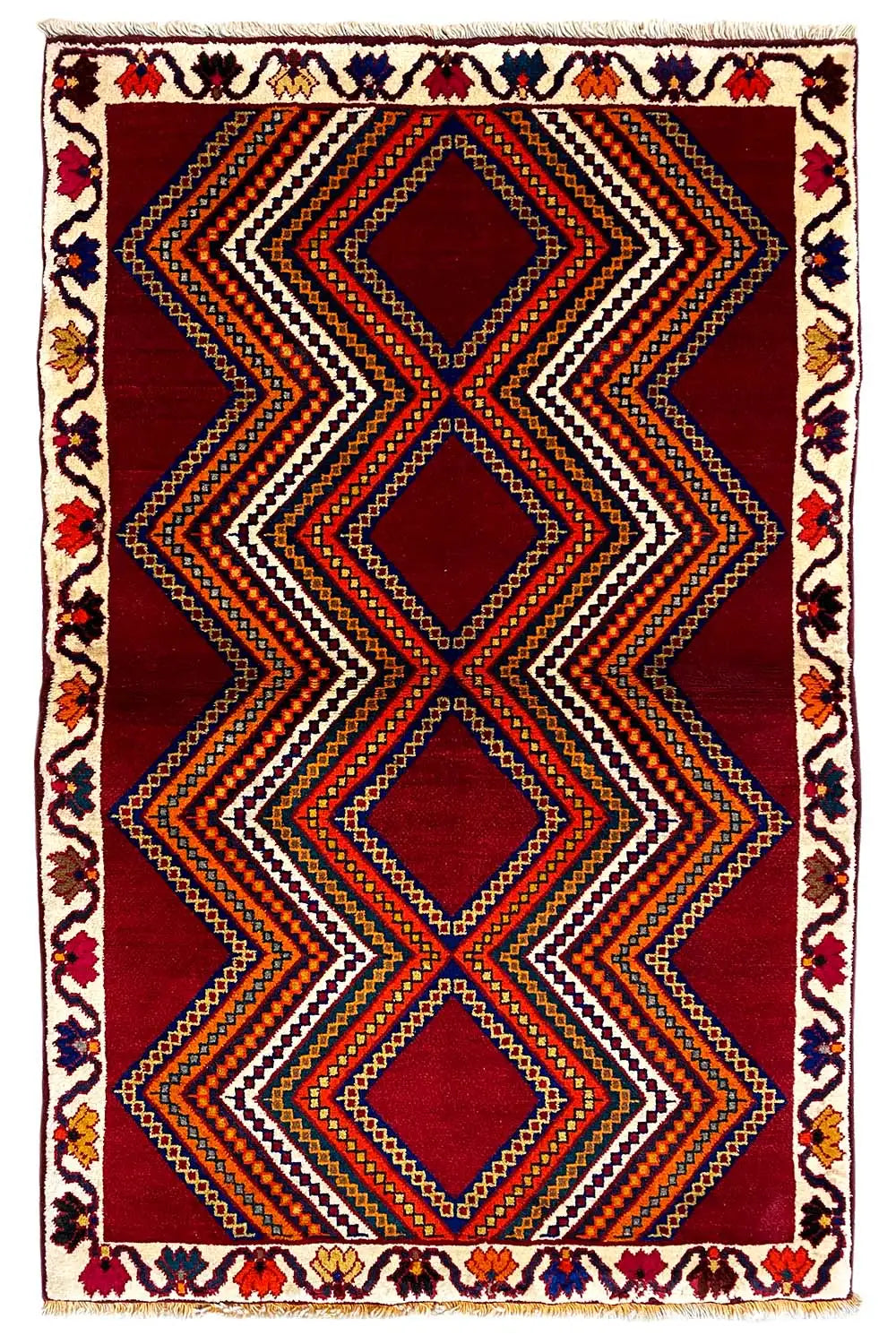 Gabbeh rug with zigzag and diamond stripes in red, black, and orange.