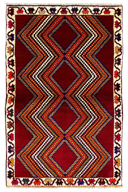 Gabbeh rug with zigzag and diamond stripes in red, black, and orange.