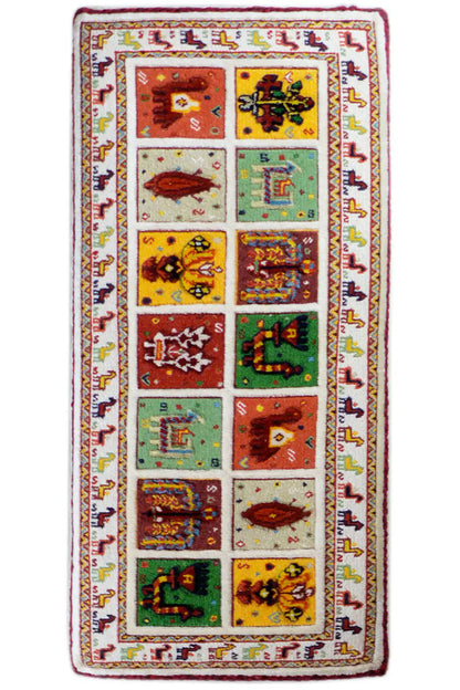 Long rectangular Soumak rug: white background with colorful patterned squares and decorative border