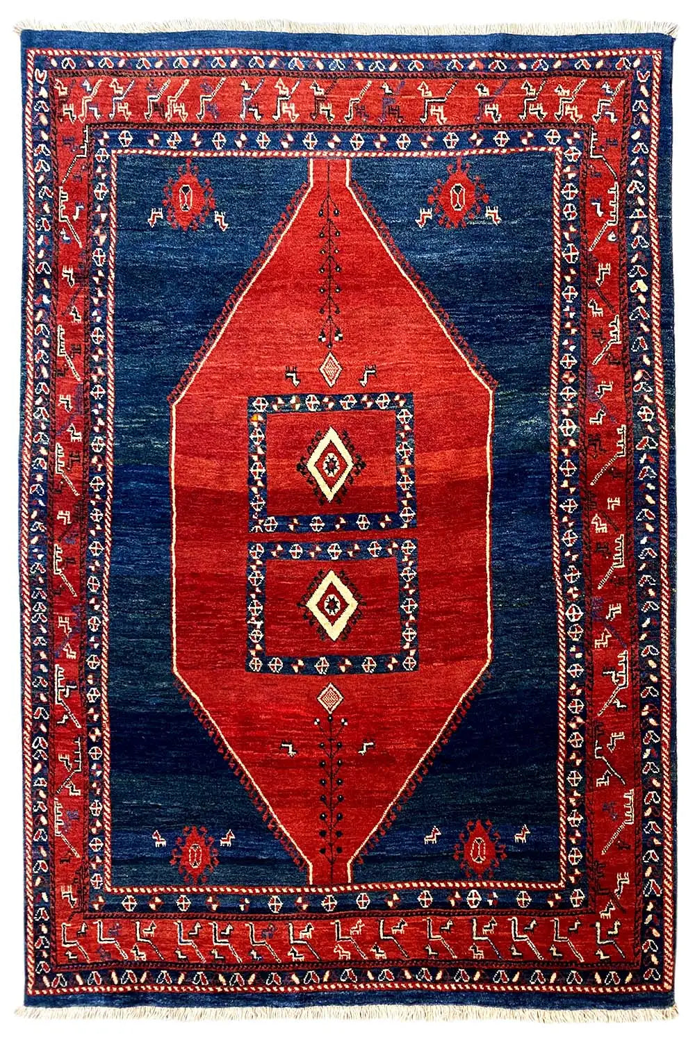 Oriental-style rug, red and blue with central diamonds and a framed pattern