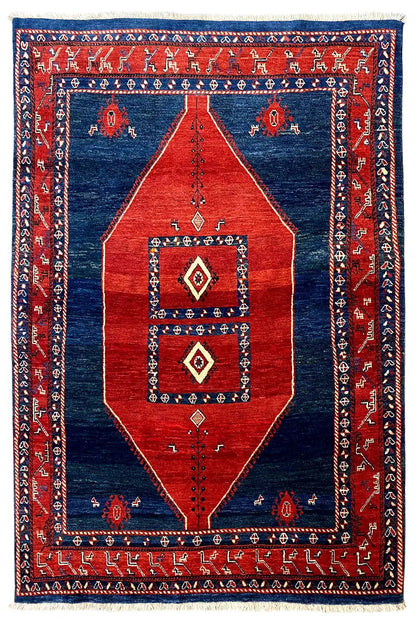 Oriental-style rug, red and blue with central diamonds and a framed pattern