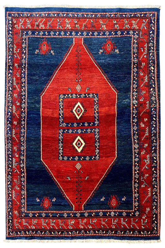 Oriental-style rug, red and blue with central diamonds and a framed pattern