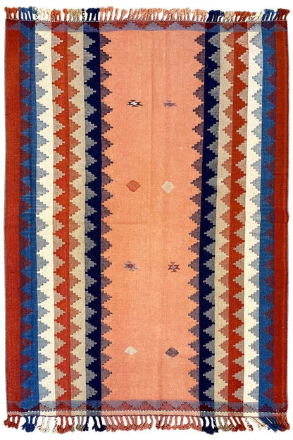 Rectangular rug with a central panel, zigzag stripes in rust and blue, fringes