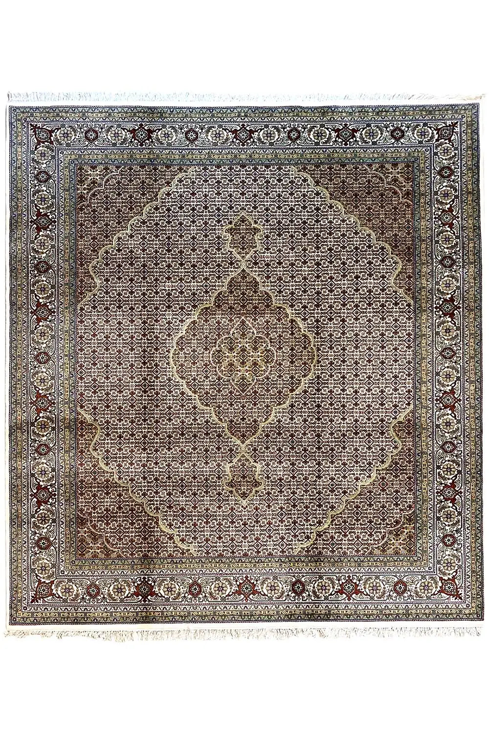 Rug with a square medallion, dark background, and ornamental border in blue and beige