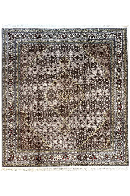 Rug with a square medallion, dark background, and ornamental border in blue and beige