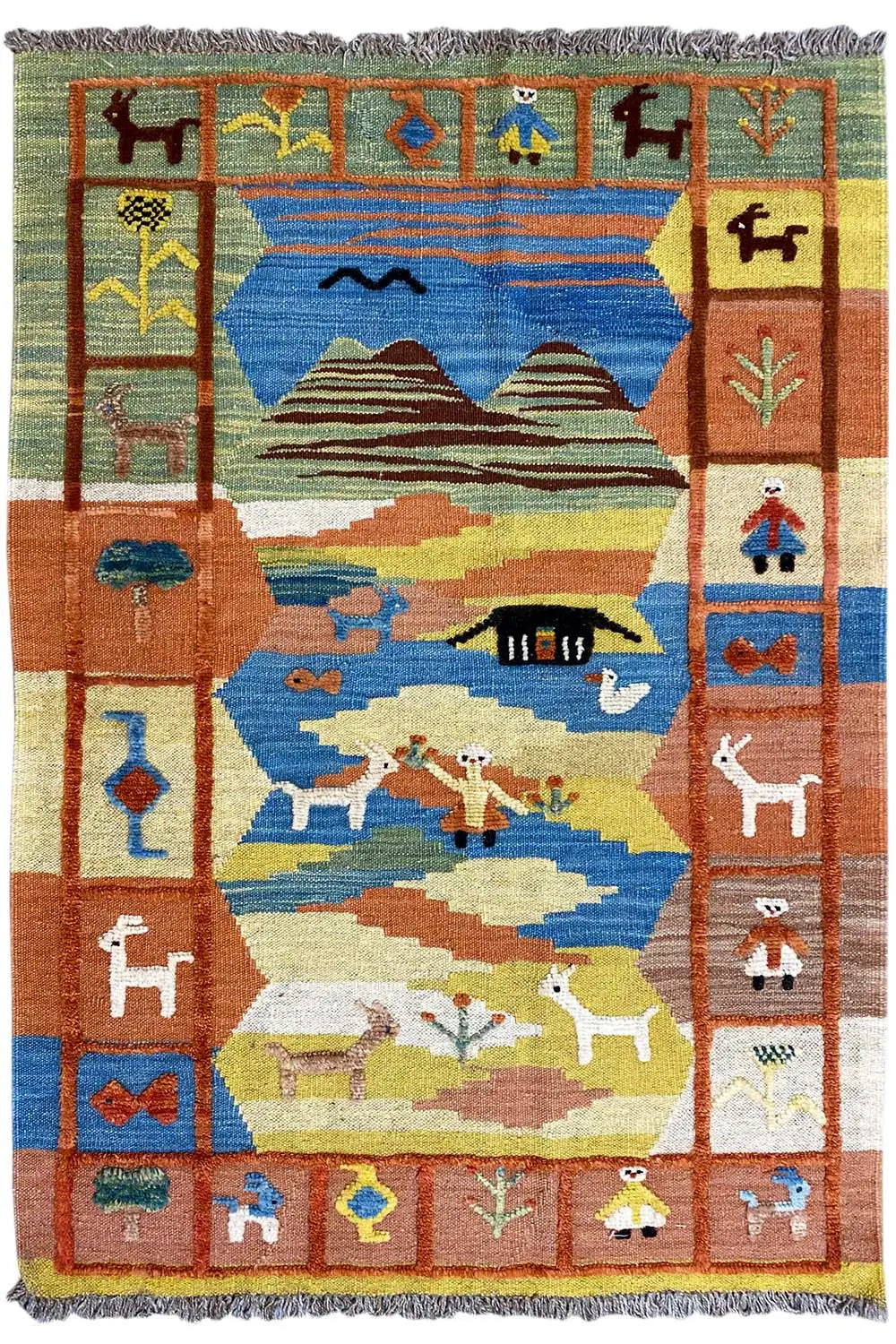 Kilim Qashqai rug with a central landscape, green and blue areas, and colorful border motifs
