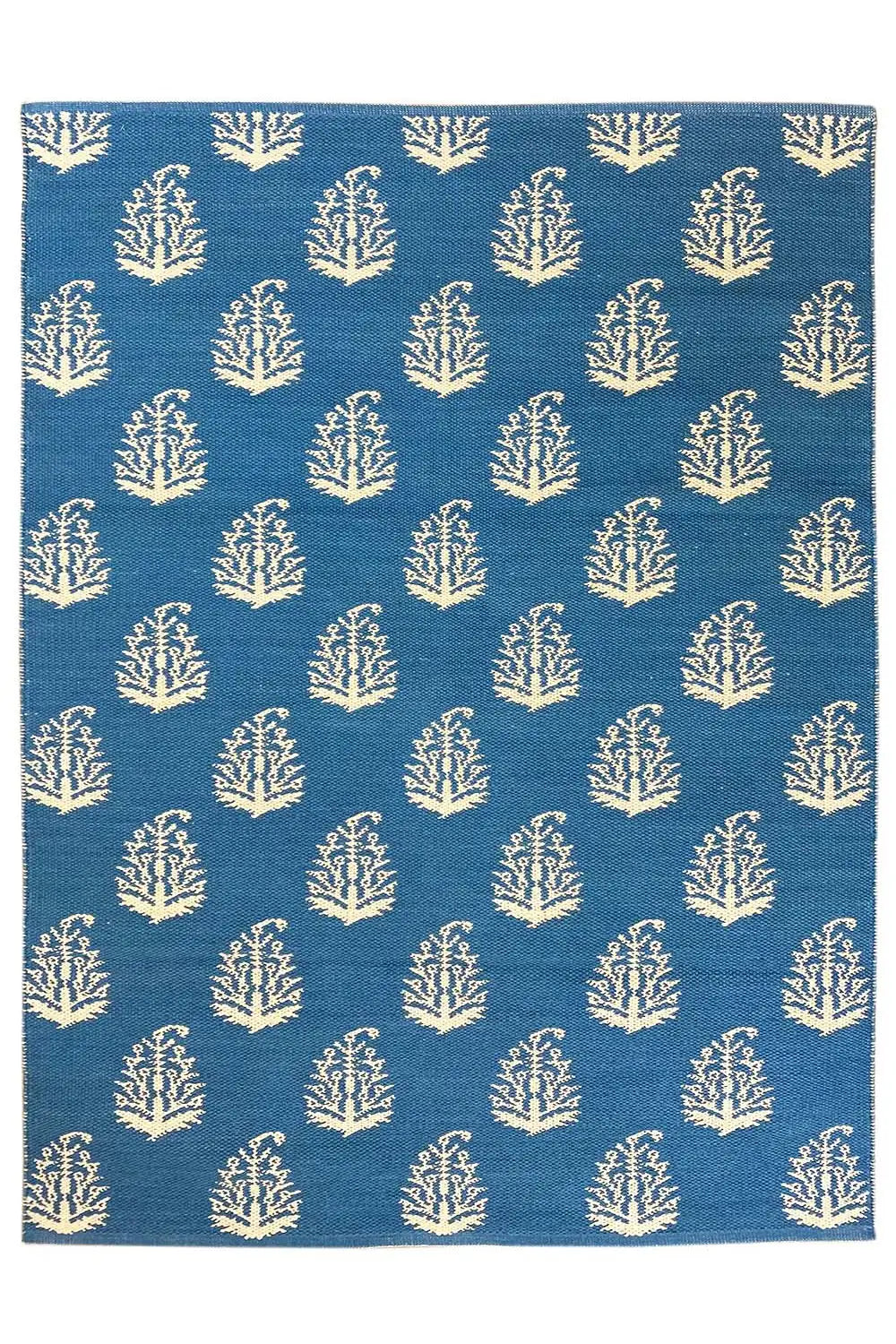 Blue kilim, square rug with repeated tree/branch motifs in cream.