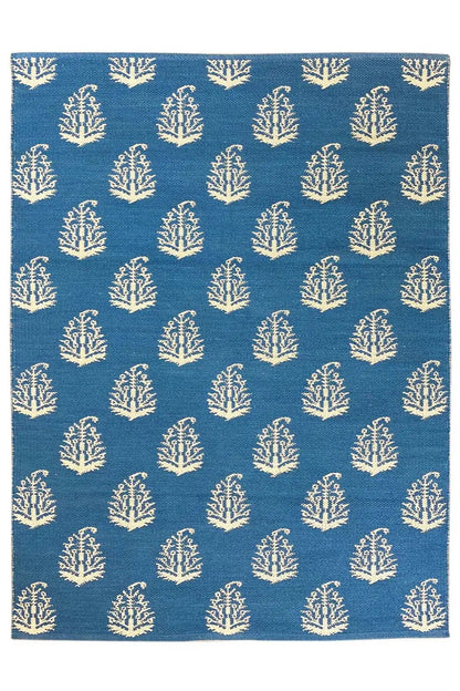 Blue kilim, square rug with repeated tree/branch motifs in cream.
