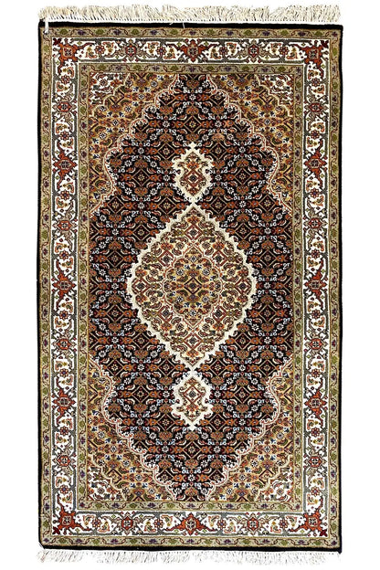 Indo Tabriz rug with central medallion, dark background and decorative border