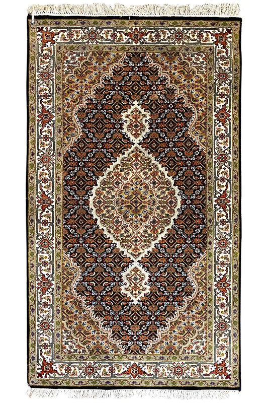 Indo Tabriz rug with central medallion, dark background and decorative border