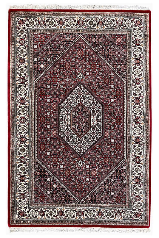 Rectangular Bidjar rug with a red field, diamond-shaped medallion, and decorative border