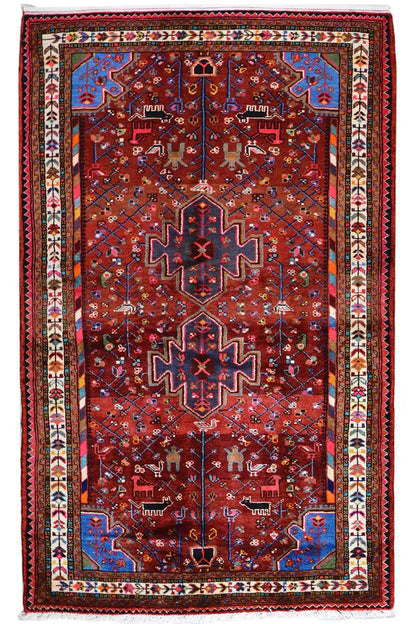 Hamadan rug, red field with symmetrical ornamentation and colorful border decoration