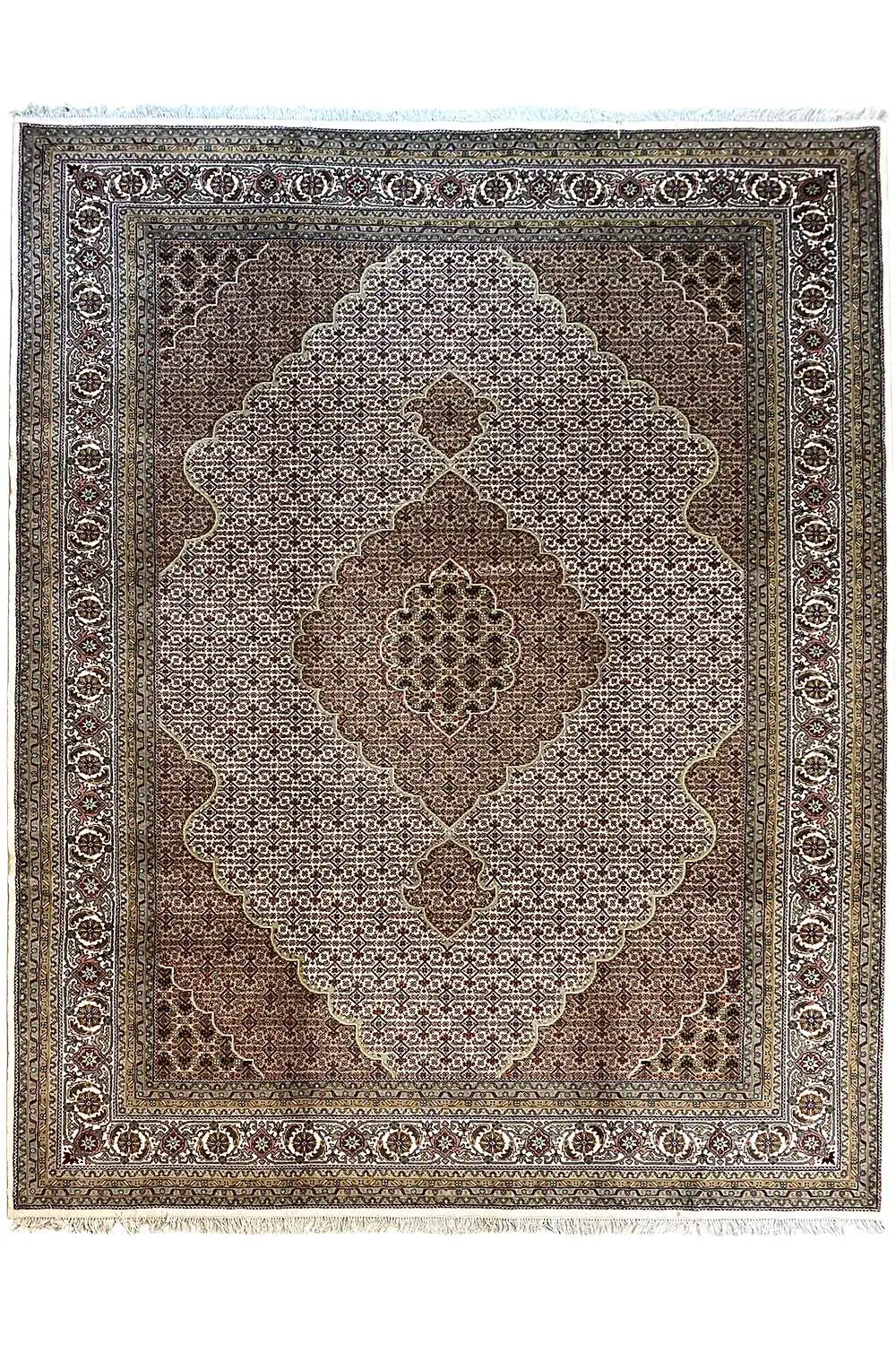 Indo Tabriz rug with a central medallion and ornamental border