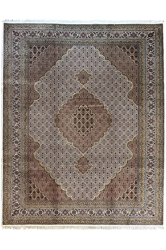 Indo Tabriz rug with a central medallion and ornamental border