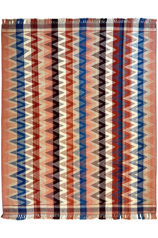 Rug with a rectangular zigzag design in rust, blue, and beige, with fringes
