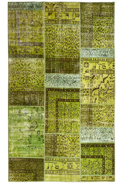 Patchwork rug, frontal, square color fields in green and beige with ornaments