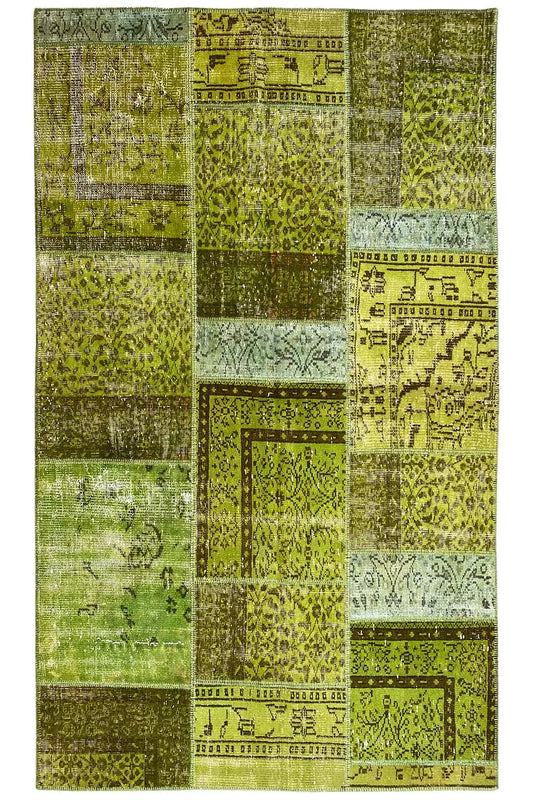 Patchwork rug, frontal, square color fields in green and beige with ornaments