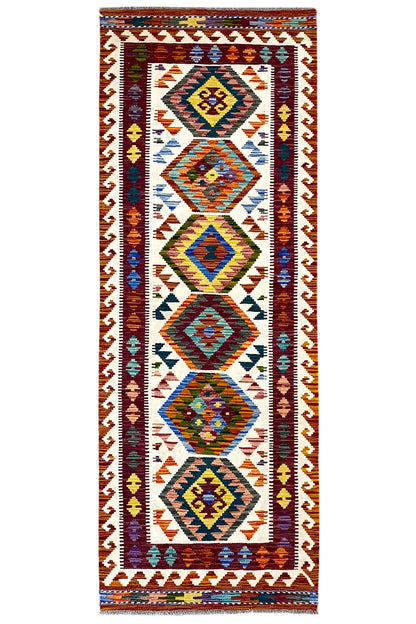 Afghan kilim runner with a colorful geometric pattern, border, and fringes