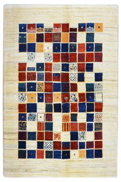 Gabbeh rug with a square patchwork pattern in blue, red, and cream