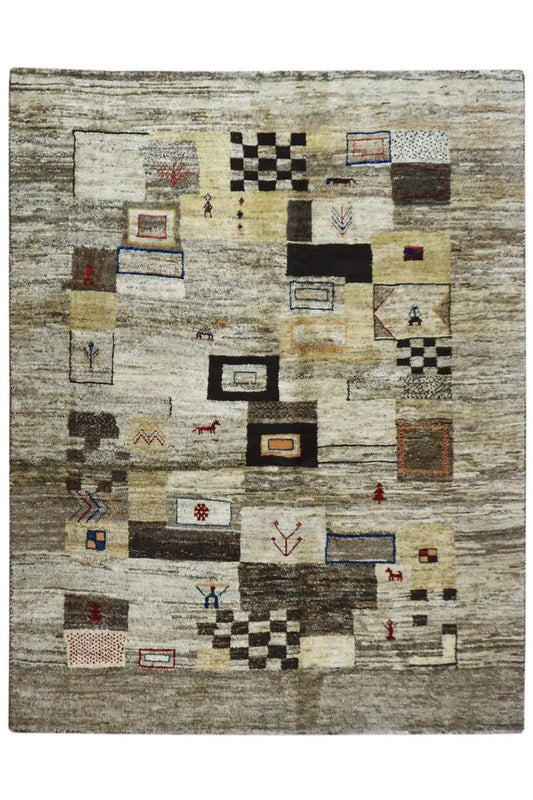 Rug with an abstract patchwork pattern in light gray, cream, black, and red/blue