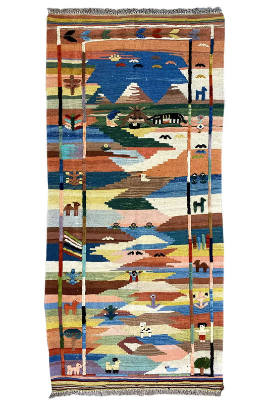 Thick kilim rug with a landscape design in blue, beige, green, and orange, with fringes all around