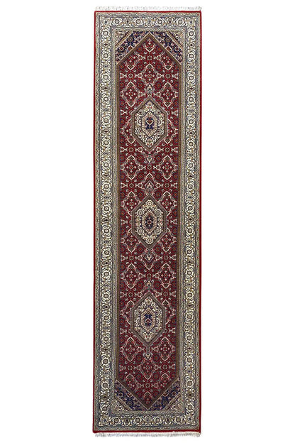 Portrait-oriented Bidjar runner with a red central motif and beige border