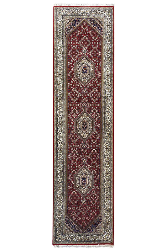 Portrait-oriented Bidjar runner with a red central motif and beige border