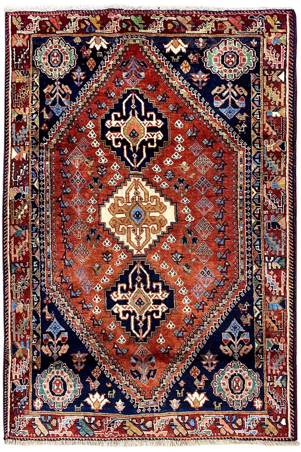 Qashqai rug (171×118 cm) with a red geometric pattern and dark border