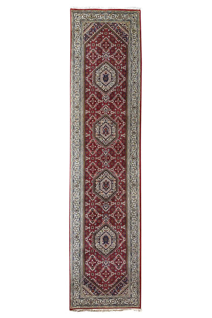 Bidjar runner with a red medallion pattern and blue-beige border, straight-on view