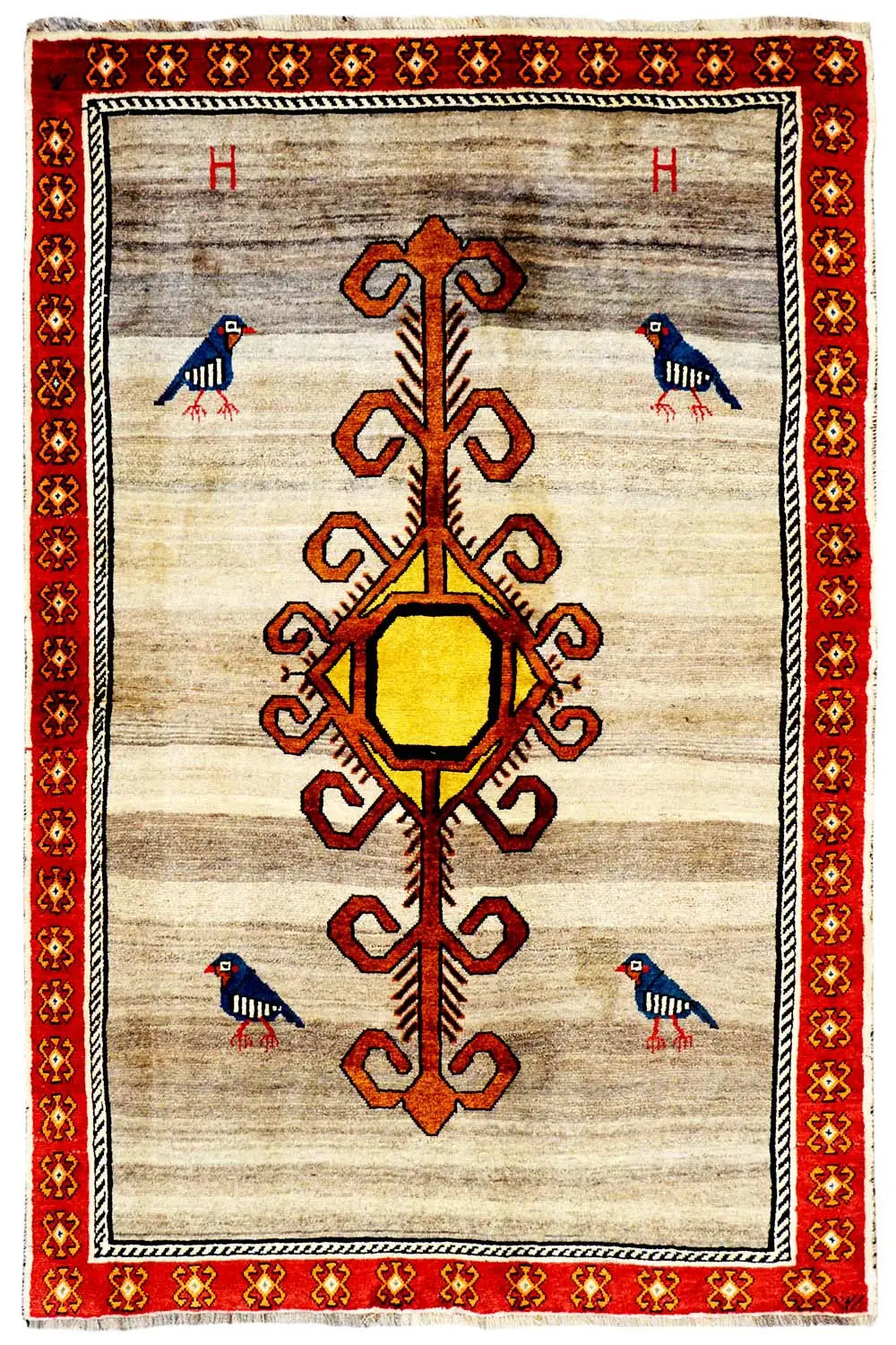 Gabbeh rug with a beige background, red border, and central medallion with an ornamental tree